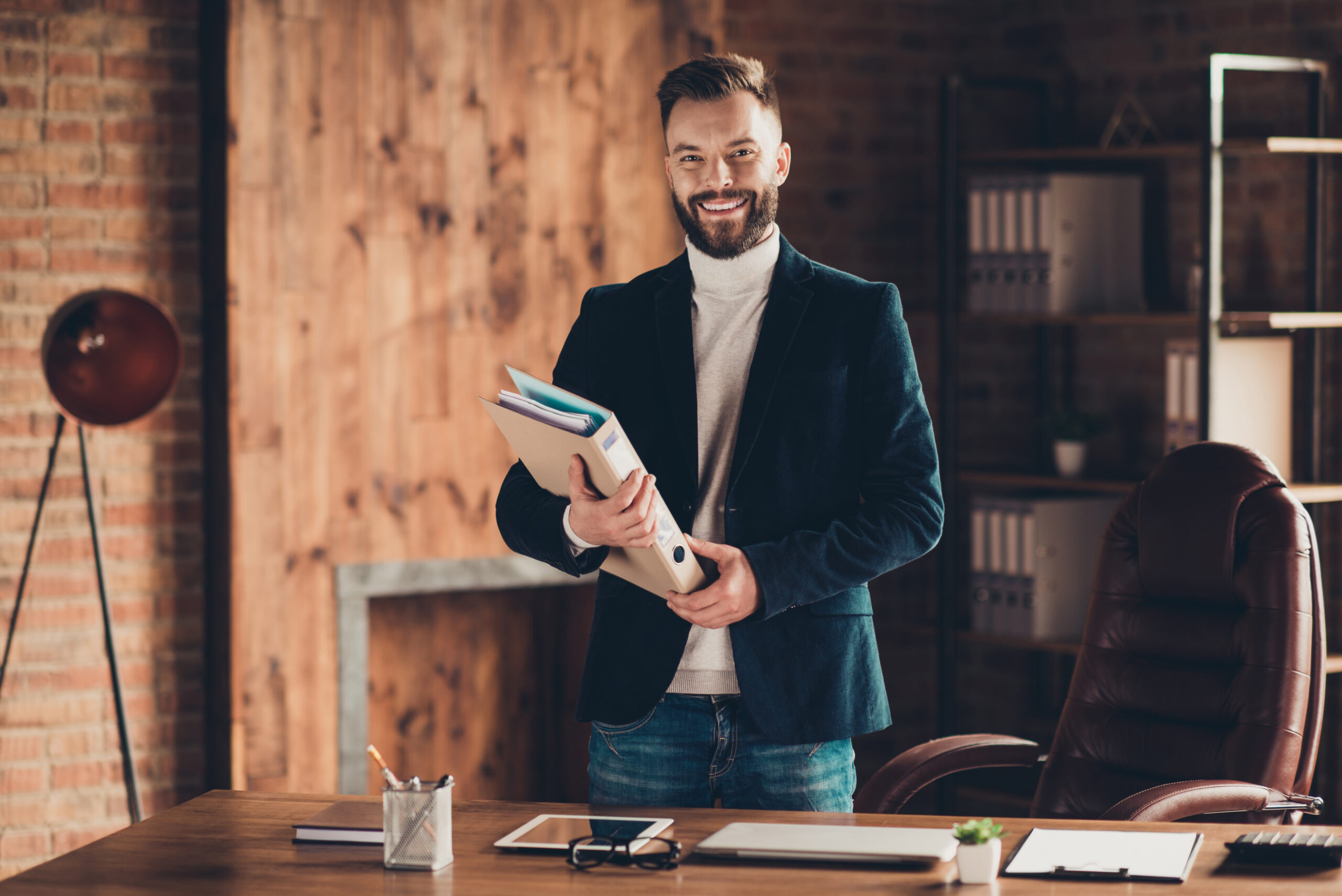 Classic elegant cheerful smart clever intelligent content bearded handsome attractive business shark, ceo, leader in black jacket, holding folder at workplace, workstation