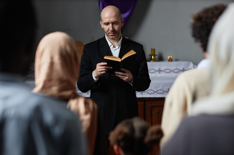 Preacher reading Bible for believers
