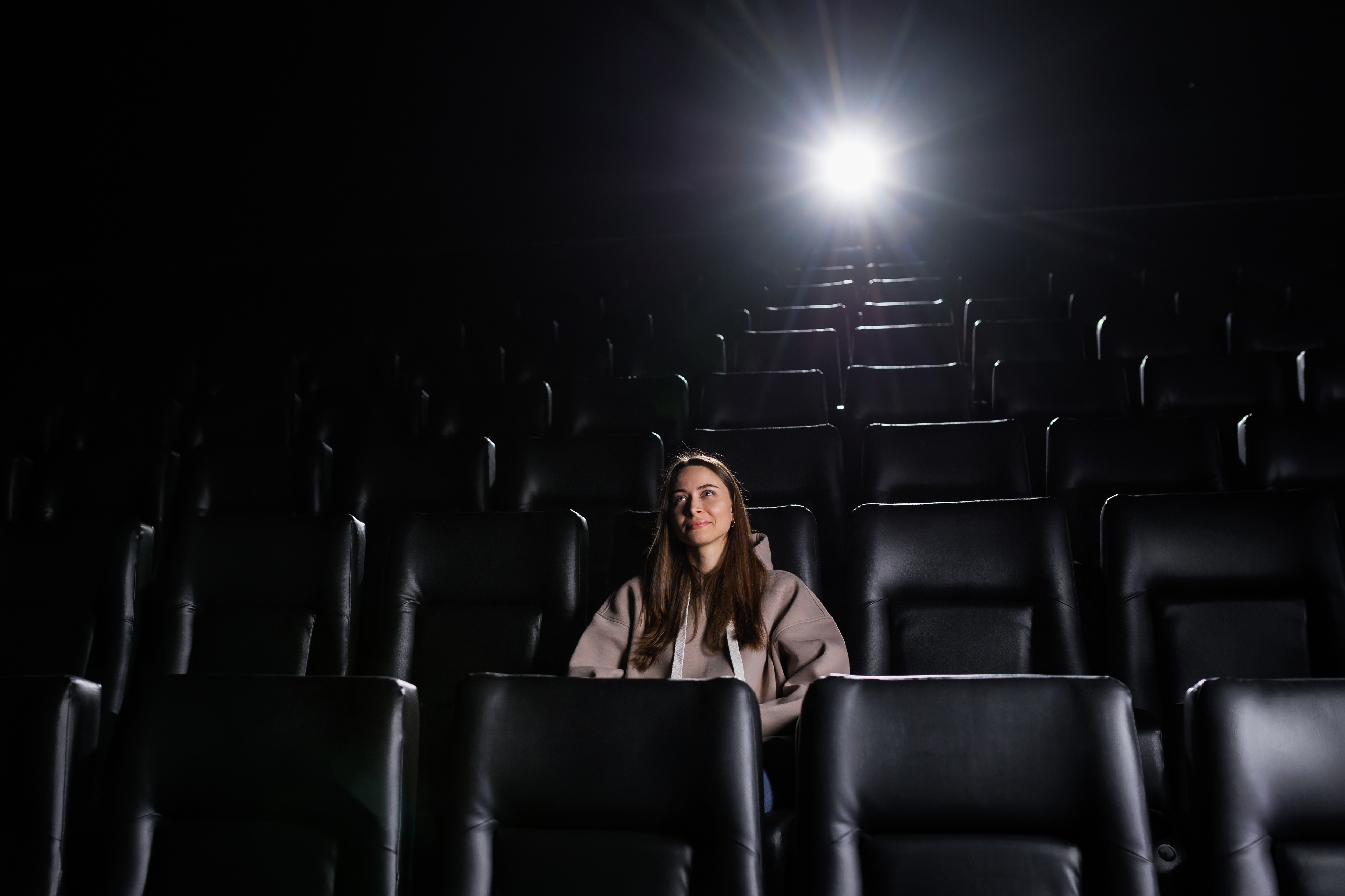 A,Young,Woman,Is,Sitting,Alone,In,A,Cinema,And