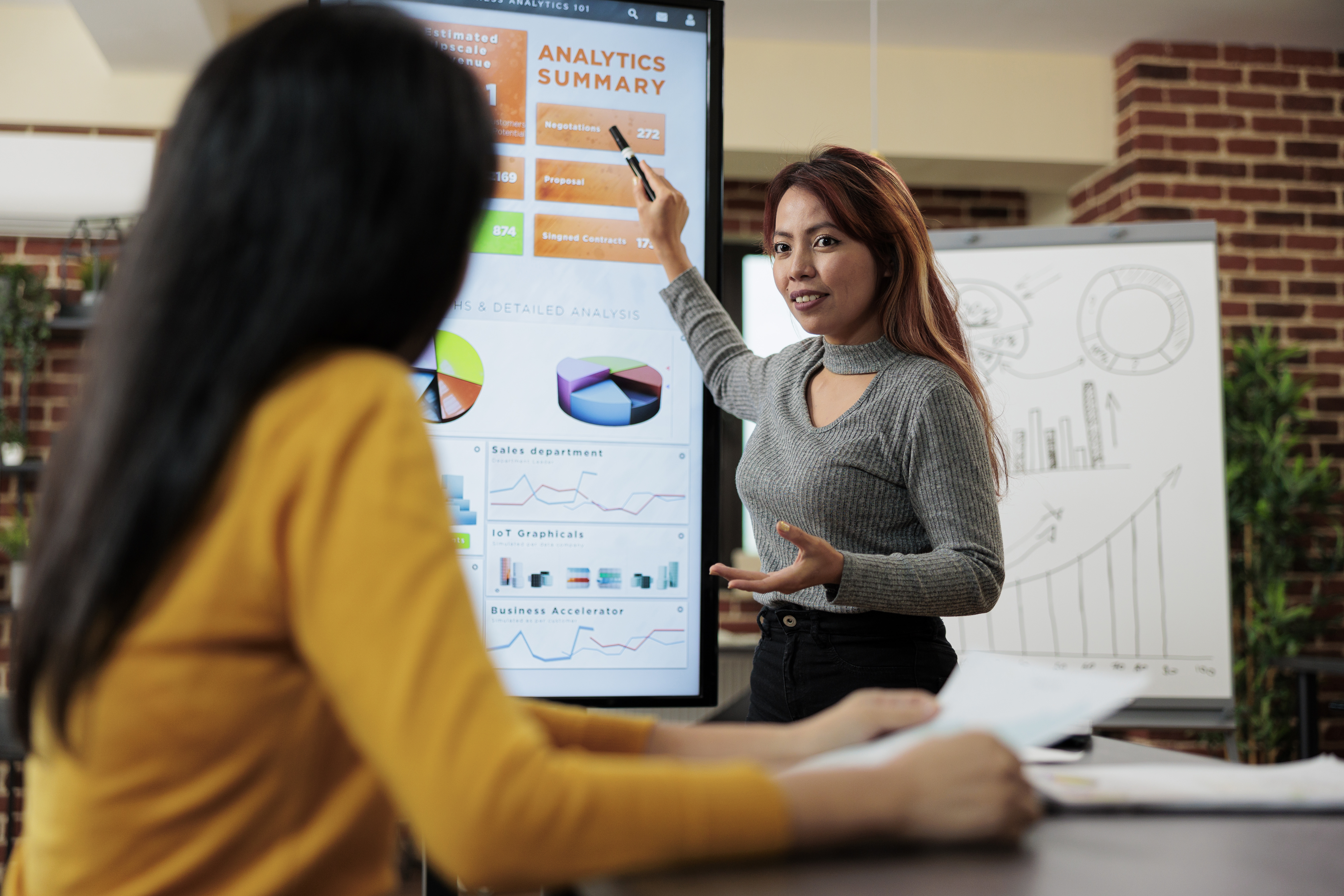 Businesswoman shwoing management graphs to executive manager