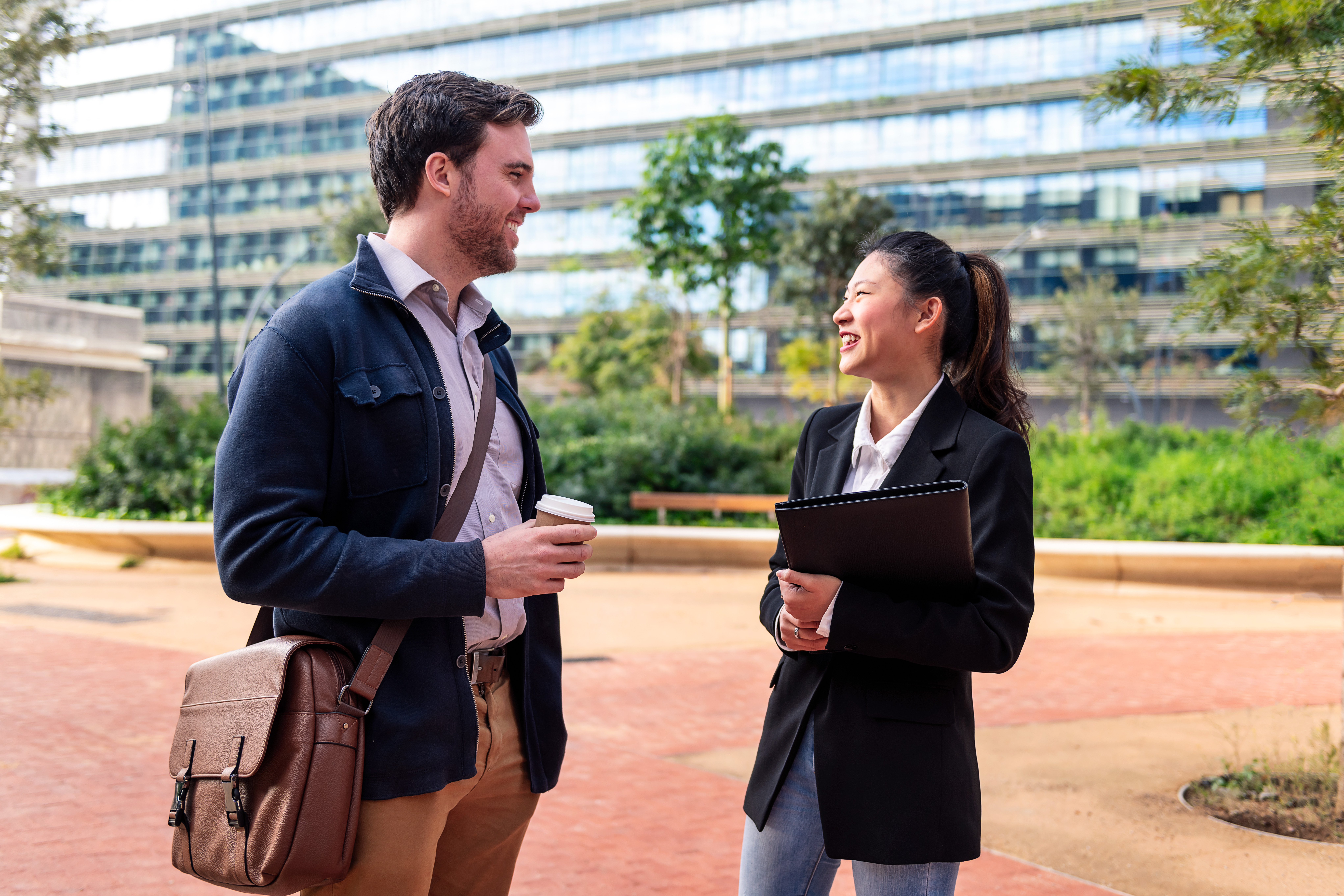 coworkers chatting in front of the office building